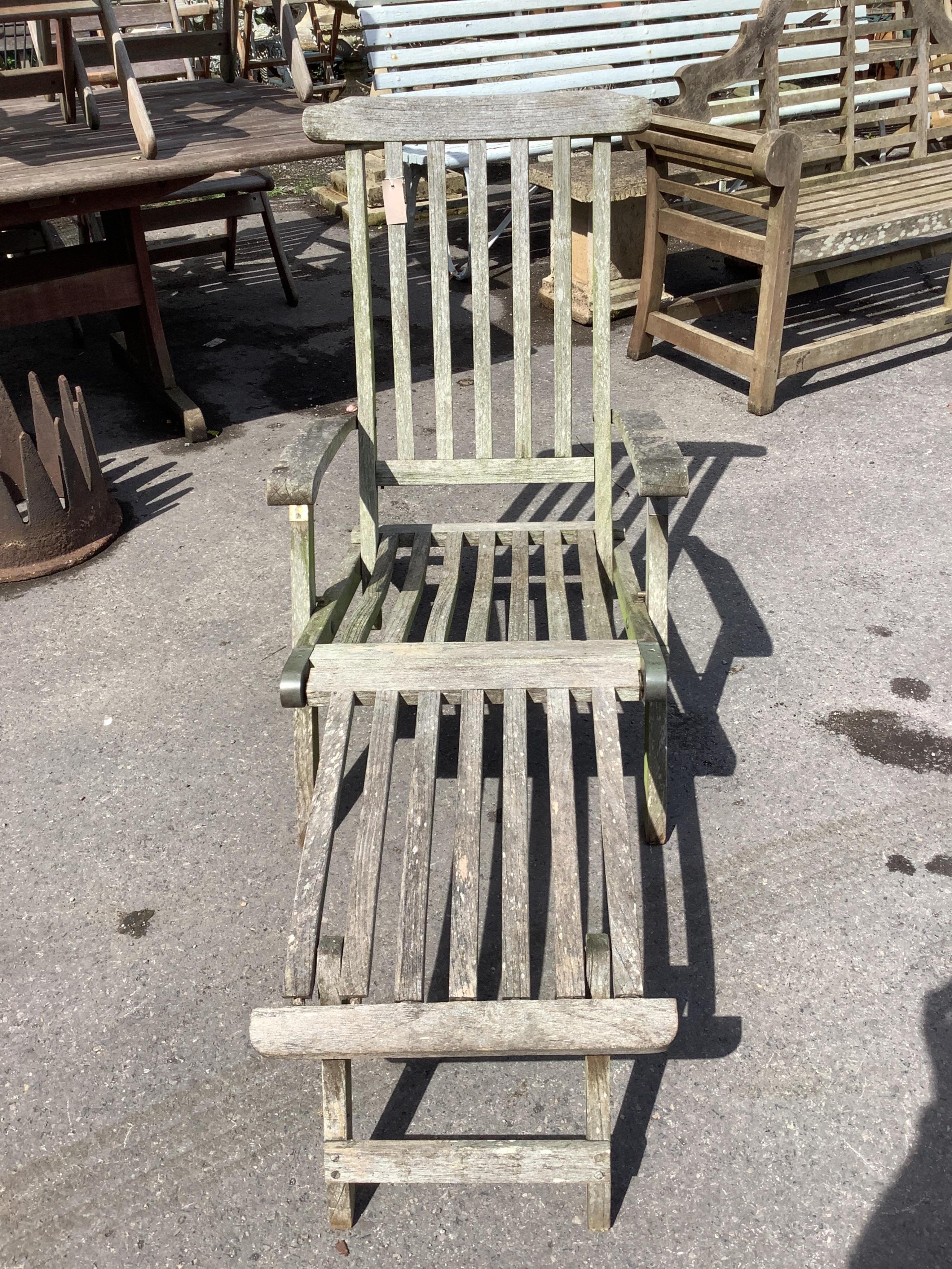 A brass mounted weathered teak steamer garden chair